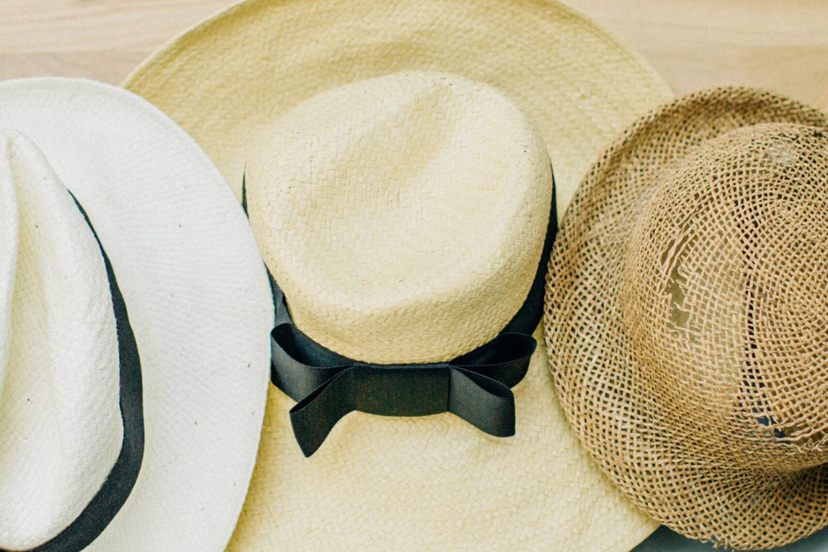 Straw hats on pastel blue background.